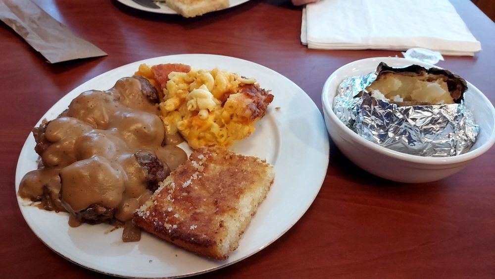 Country steak with gravy, mac and cheese, cornbread and a baked potato