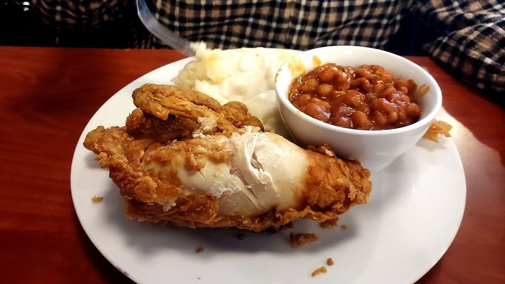 Fried chicken breast with baked beans and mashed potatoes